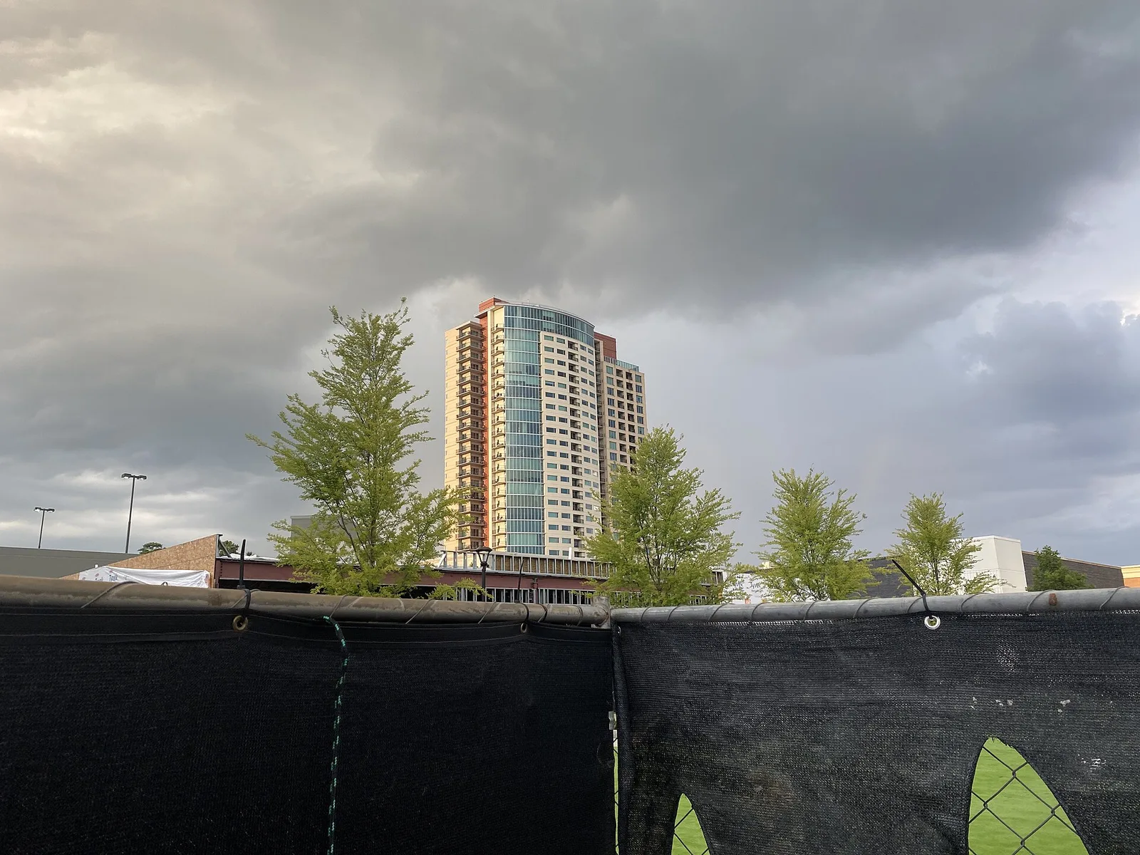 A construction fence and an office tower on Olde Perimeter Way in Dunwoody's Perimeter Center