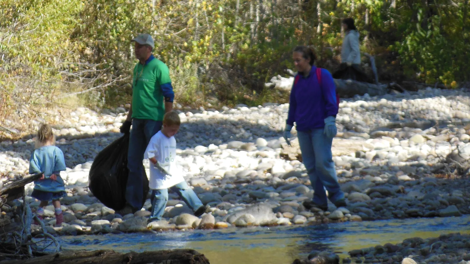 Volunteers clear trash from a creek bed during a National Park Service cleanup. The picture does not show Dunwoody.