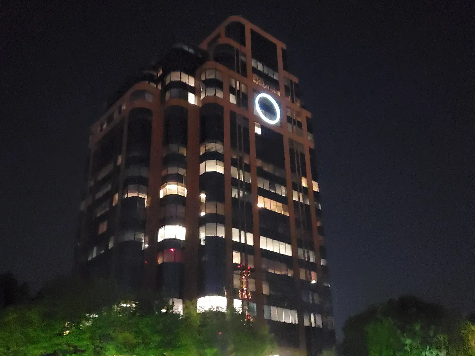 The 1050 Crown Pointe office tower lit up at night in Perimeter Center