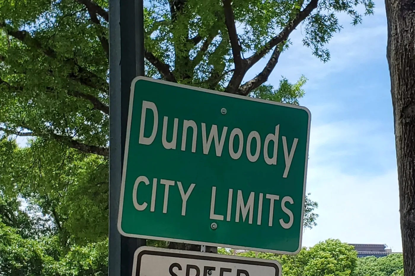 A Dunwoody city limits sign; school attendance zones do not follow the city line